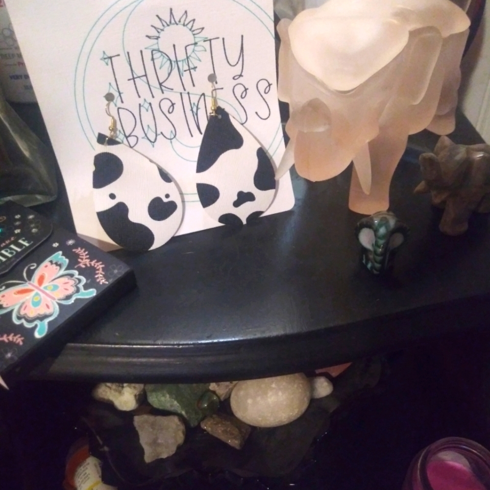 Cow print faux leather earrings.